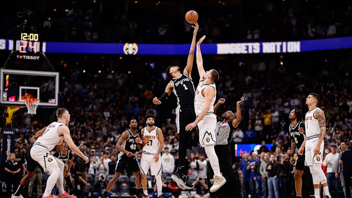 Jan 3, 2025; Denver, Colorado, USA; San Antonio Spurs center Victor Wembanyama (1) and Denver Nuggets center Nikola Jokic (15) jump for the ball to start the game at Ball Arena. Mandatory Credit: Isaiah J. Downing-Imagn Images