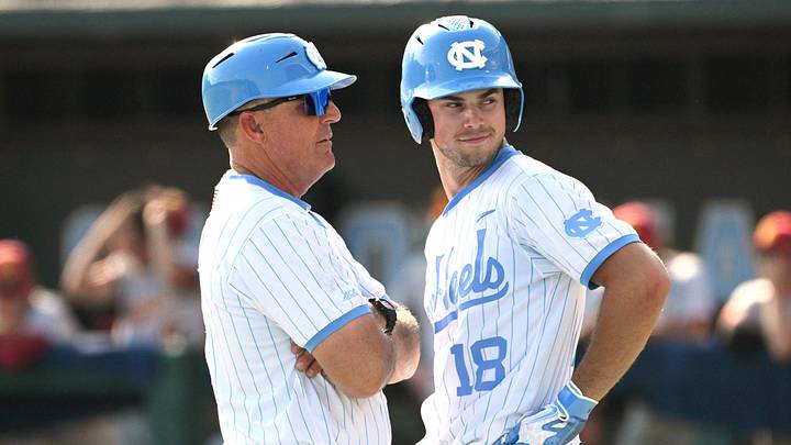 June 7, 2026; Chapel Hill, NC, USA;  North Carolina Tar Heels head coach Scott Forbes coaches outfielder Carter French (18) during the ninth inning against the USC Trojans at Boshamer Stadium. Mandatory Credit: Zachary Taft-Imagn Images