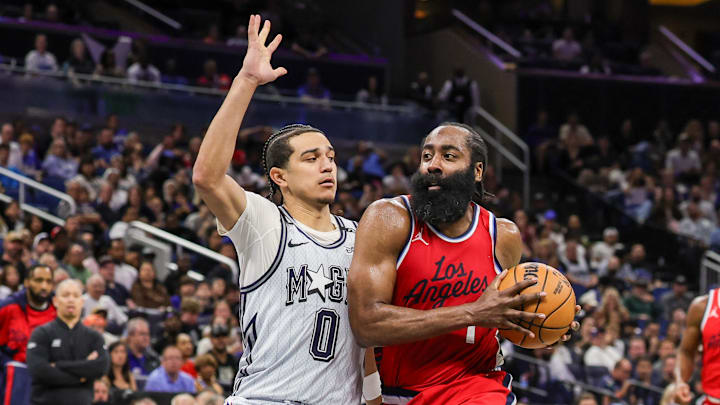 Mar 31, 2025; Orlando, Florida, USA; LA Clippers guard James Harden (1) drives against Orlando Magic guard Anthony Black (0) during the second half at Kia Center. Mandatory Credit: Mike Watters-Imagn Images