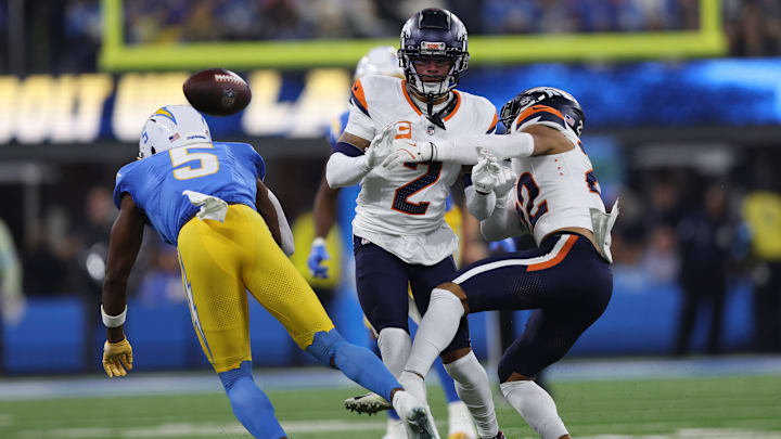 December 19, 2024, Inglewood, California, USA: Denver Broncos safety BRANDON JONES (22) and cornerback PATRICK SURTAIN II (2) challenge a catch attempt from Los Angeles Chargers wide receiver JOSH PALMER (5) during a NFL, American Football Herren, USA football game between the Denver Broncos and the Los Angeles Chargers at SoFi Stadium in Inglewood, California.