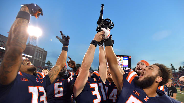Oct 12, 2024; Champaign, Illinois, USA; Fighting Illinois players celebrate with the Purdue Cannon in a 50-49 win against the Purdue Boilermakers at Memorial Stadium. Mandatory Credit: Ron Johnson-Imagn Images Oct 12, 2024; Champaign, Illinois, USA; Fighting Illinois players celebrate with the Purdue Cannon in a 50-49 win against the Purdue Boilermakers at Memorial Stadium. Mandatory Credit: Ron Johnson-Imagn Images