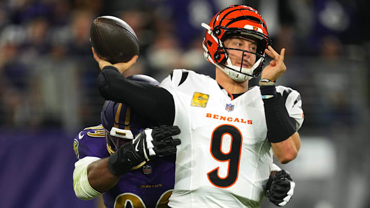 Nov 7, 2024; Baltimore, Maryland, USA; Cincinnati Bengals quarterback Joe Burrow (9) is pressured by Baltimore Ravens linebacker Odafe Oweh (99) during the first quarter at M&T Bank Stadium. Mandatory Credit: Mitch Stringer-Imagn Images