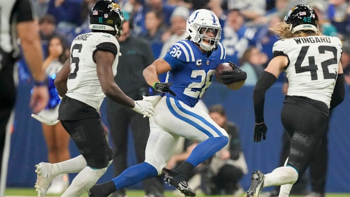 Indianapolis Colts running back Jonathan Taylor (28) rushes runs toward the sideline as Jacksonville Jaguars safety Darnell Savage (6) and Jacksonville Jaguars safety Andrew Wingard (42) close in Sunday, Jan. 5, 2025, during a game against the Jacksonville Jaguars at Lucas Oil Stadium in Indianapolis.