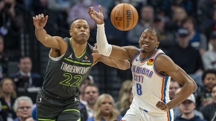 Feb 23, 2025; Minneapolis, Minnesota, USA; Minnesota Timberwolves guard Jaylen Clark (22) and Oklahoma City Thunder forward Jalen Williams (8) go after a loose ball in the first half at Target Center. Mandatory Credit: Jesse Johnson-Imagn Images