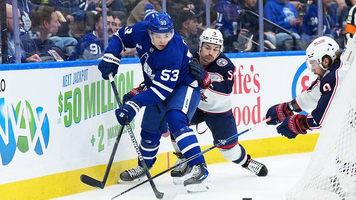 Nov 20, 2025; Toronto, Ontario, CAN; Toronto Maple Leafs right wing Easton Cowan (53) battles behind the net with Columbus Blue Jackets defenseman Denton Mateychuk (5) during the first period at Scotiabank Arena. Mandatory Credit: Nick Turchiaro-Imagn Images