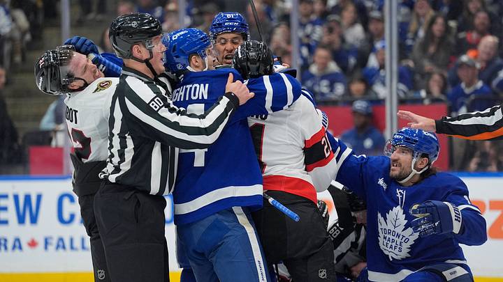 Linesperson Jonathan Deschamps tries to break up a scrum between Toronto Maple Leafs forward Scott Laughton (24) Toronto Maple Leafs forward Dakota Joshua (81) and Toronto Maple Leafs defenseman Chris Tanev (8) and Ottawa Senators forward Nick Cousins (21) and defenseman Thomas Chabot (72): John E. Sokolowski-Imagn Images