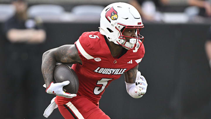 Louisville Cardinals wide receiver Caullin Lacy (5) runs the ball against the James Madison Dukes during the first half at L&N Federal Credit Union Stadium. Louisville defeated James Madison 28-14.