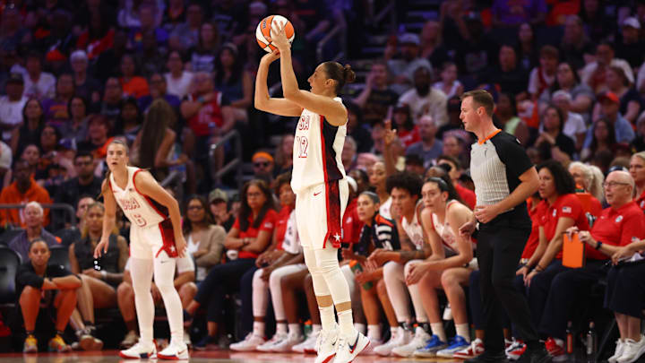 Jul 20, 2024; Phoenix, AZ, USA; USA Women's National Team guard Diana Taurasi (12) takes a shot at the basket during the first half against the Team WNBA at Footprint Center. Mandatory Credit: Mark J. Rebilas-Imagn Images