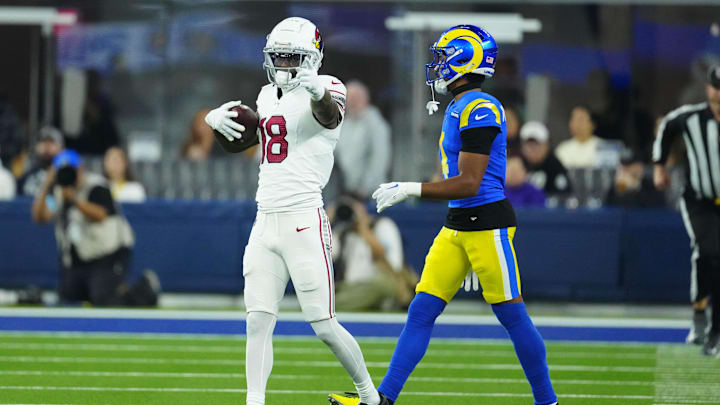 Dec 28, 2024; Inglewood, California, USA; Arizona Cardinals wide receiver Marvin Harrison Jr. (18) gestures after catching the ball against Los Angeles Rams cornerback Ahkello Witherspoon (4) in the first half at SoFi Stadium. Mandatory Credit: Kirby Lee-Imagn Images