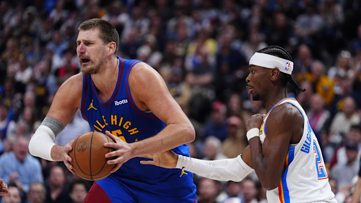 May 9, 2025; Denver, Colorado, USA; Oklahoma City Thunder guard Shai Gilgeous-Alexander (2) defends on Denver Nuggets center Nikola Jokic (15) in the second half during game three of the second round for the 2025 NBA Playoffs at Ball Arena. Mandatory Credit: Ron Chenoy-Imagn Images