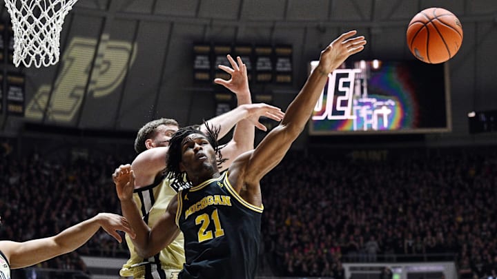 Feb 17, 2026; West Lafayette, Indiana, USA; Michigan Wolverines forward Morez Johnson Jr. (21) has a rebound knocked away by Purdue Boilermakers center Oscar Cluff (45) during the first half at Mackey Arena. Feb 17, 2026; West Lafayette, Indiana, USA; Michigan Wolverines forward Morez Johnson Jr. (21) has a rebound knocked away by Purdue Boilermakers center Oscar Cluff (45) during the first half at Mackey Arena.