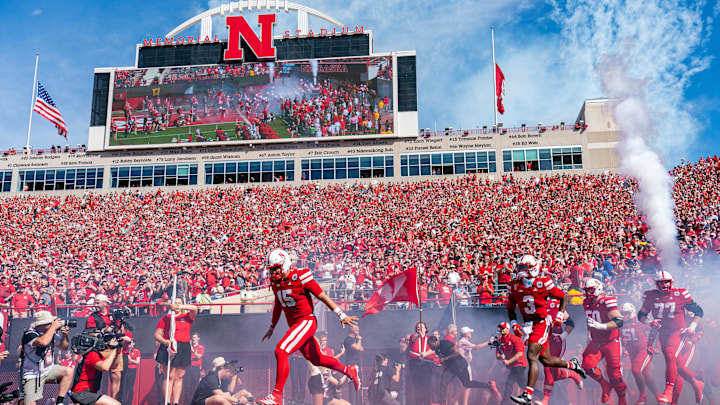 Sep 13, 2025; Lincoln, Nebraska, USA; The Nebraska Cornhuskers run onto the field before the game against the Houston Christian Huskies at Memorial Stadium. Mandatory Credit: Dylan Widger-Imagn Images