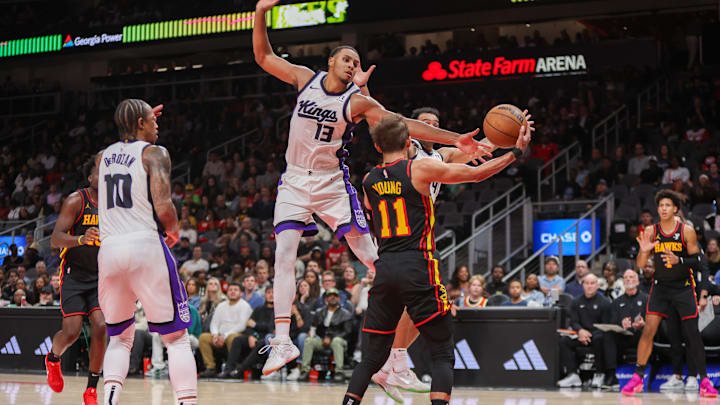 Nov 1, 2024; Atlanta, Georgia, USA; Sacramento Kings forward Keegan Murray (13) defends Atlanta Hawks guard Trae Young (11) in the fourth quarter at State Farm Arena. Mandatory Credit: Brett Davis-Imagn Images