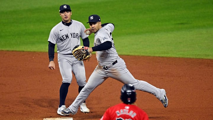 Oct 19, 2024; Cleveland, Ohio, USA; New York Yankees second base Gleyber Torres (25) turns a double play over Cleveland Guardians catcher Bo Naylor (23) during the seventh inning during game five of the ALCS for the 2024 MLB playoffs at Progressive Field. Mandatory Credit: David Richard-Imagn Images