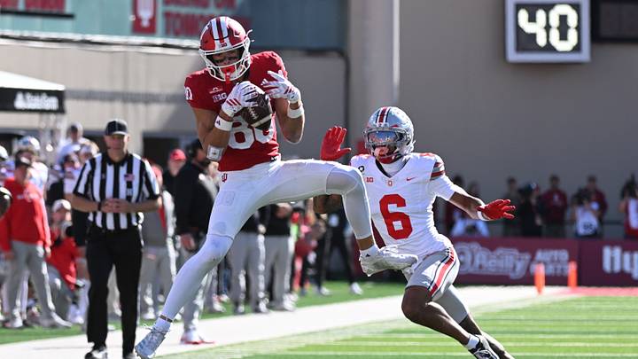 Oct 17, 2026; Bloomington, Indiana, USA;  Indiana Hoosiers wide receiver Charlie Becker (80) makes a catch in front of Indiana Hoosiers defensive back Preston Zachman (6) during the second half at Merchants Bank Field at Memorial Stadium.  Mandatory Credit: Robert Goddin-Imagn Images