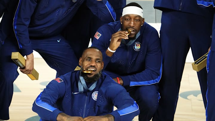 Aug 10, 2024; Paris, France; United States guard LeBron James (6) and centre Bam Adebayo (13) celebrate with their gold medals after defeating France in the men's basketball gold medal game during the Paris 2024 Olympic Summer Games at Accor Arena. Mandatory Credit: Rob Schumacher-Imagn Images