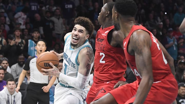 Nov 27, 2024; Charlotte, North Carolina, USA;  Charlotte Hornets guard LaMelo Ball (1) drives in past Miami Heat guard Terry Rozier III (2) during the second half at the Spectrum Center. Mandatory Credit: Sam Sharpe-Imagn Images