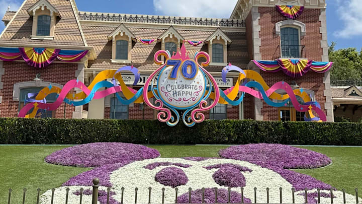 A Mickey Mouse topiary display welcomes guests to the entrance to Disneyland Park for its 70th anniversary.