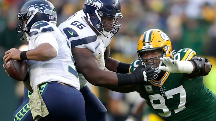 Seattle Seahawks guard Gabe Jackson (66) blocks Green Bay Packers nose tackle Kenny Clark (97) as he chases quarterback Russell Wilson (3) during their football game on Sunday November 14, 2021, at Lambeau Field in Green Bay, Wis. Wm. Glasheen 