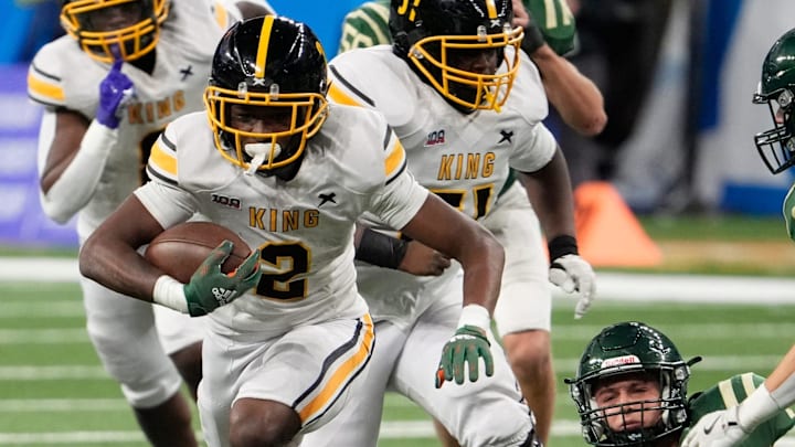 Detroit Martin Luther King's Michael Dukes (2) runs for extra yardage during his teams 42-22 loss against Zealand West in the MHSAA Division 3 high school football final at Ford Field in Detroit on Saturday, Nov. 30, 2024.