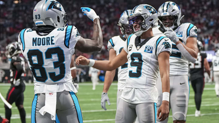 Jan 5, 2025; Atlanta, Georgia, USA; Carolina Panthers quarterback Bryce Young (9) reacts with wide receiver David Moore (83) after running for a touchdown against the Atlanta Falcons during the second half at Mercedes-Benz Stadium. 