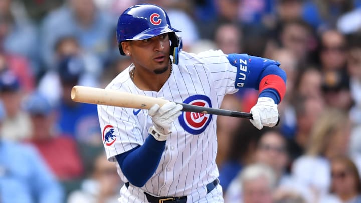 Sep 29, 2024; Chicago, Illinois, USA; Chicago Cubs shortstop Luis Vazquez (12) bunts for his first MLB hit during the seventh inning against the Cincinnati Reds at Wrigley Field