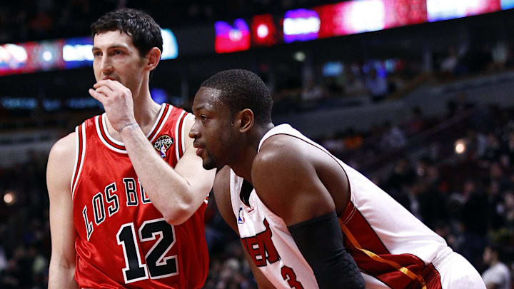 Mar 25, 2010; Chicago, IL, USA;  Chicago Bulls guard Kirk Hinrich (12) and Miami Heat guard Dwyane Wade (3) talk during the second half at the United Center. The Miami Heat defeated the Chicago Bulls 103-74. Mandatory Credit: Mike DiNovo-Imagn Images