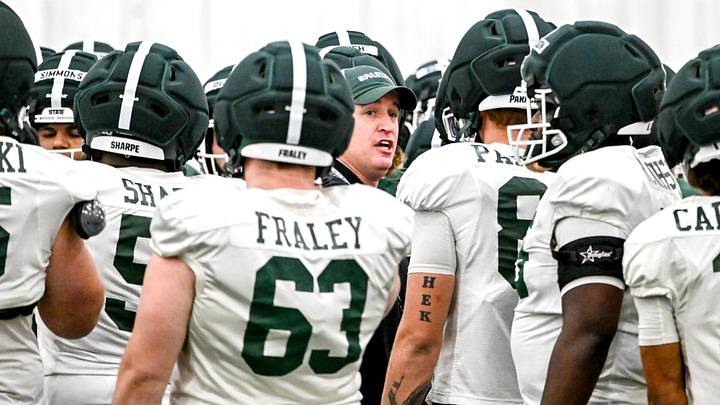 Michigan State's head coach Pat Fitzgerald, center, huddles up with the team during spring football practice on Tuesday, April 14, 2026, in East Lansing.