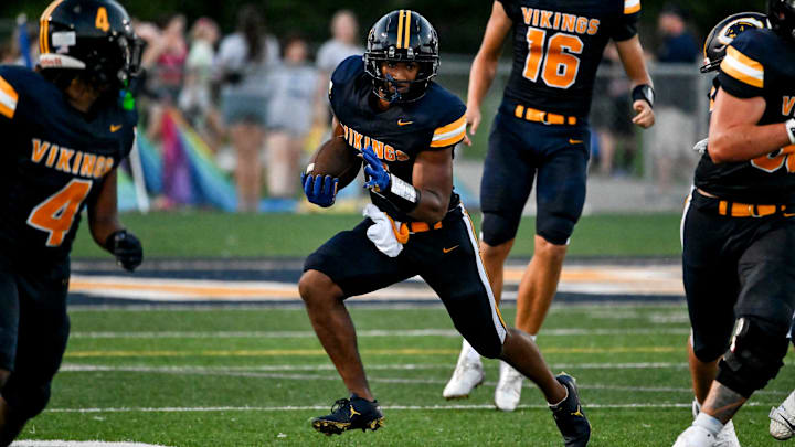 Haslett's Kory Amachree runs for a gain against DeWitt during the second quarter on Thursday, Aug. 29, 2024, at Haslett High School.