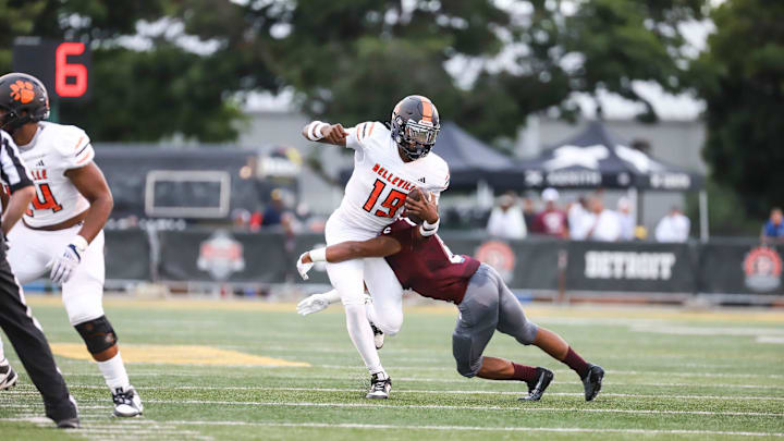Belleville quarterback Bryce Underwood (19) is tackled by River Rouge linebacker Christian Matthews