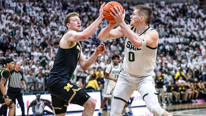 Michigan State's Jaxon Kohler, right, shoots as Michigan's Danny Wolf defends during the second half on Sunday, March 9, 2025, at the Breslin Center in East Lansing.