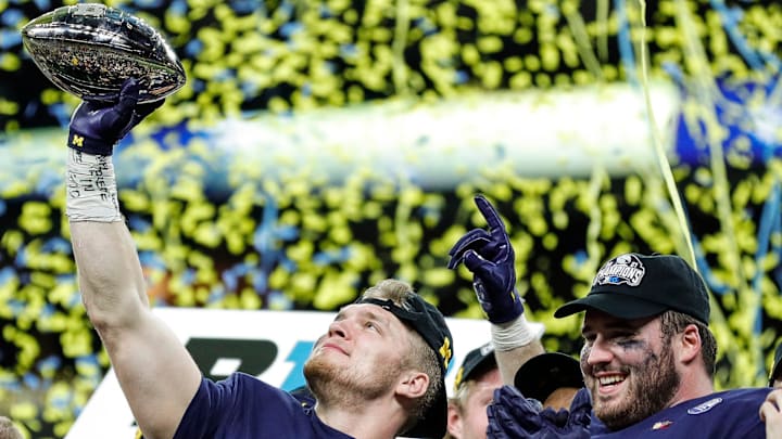 Michigan defensive end Aidan Hutchinson lifts the Big Ten championship trophy after the 42-3 win over Iowa in the Big Ten championship game Dec. 4, 2021, in Indianapolis.
Syndication Detroit Free Press Michigan defensive end Aidan Hutchinson lifts the Big Ten championship trophy after the 42-3 win over Iowa in the Big Ten championship game Dec. 4, 2021, in Indianapolis.
Syndication Detroit Free Press