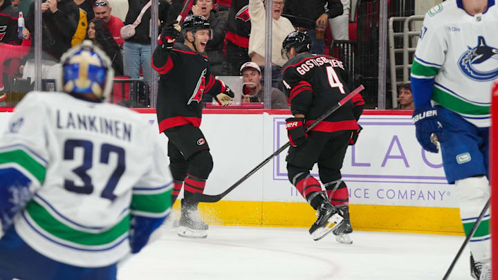 Nov 14, 2025; Raleigh, North Carolina, USA; Carolina Hurricanes left wing Taylor Hall (71) celebrates his goal with defenseman Shayne Gostisbehere (4) against the Vancouver Canucks during the third period at Lenovo Center. Mandatory Credit: James Guillory-Imagn Images Nov 14, 2025; Raleigh, North Carolina, USA; Carolina Hurricanes left wing Taylor Hall (71) celebrates his goal with defenseman Shayne Gostisbehere (4) against the Vancouver Canucks during the third period at Lenovo Center. Mandatory Credit: James Guillory-Imagn Images