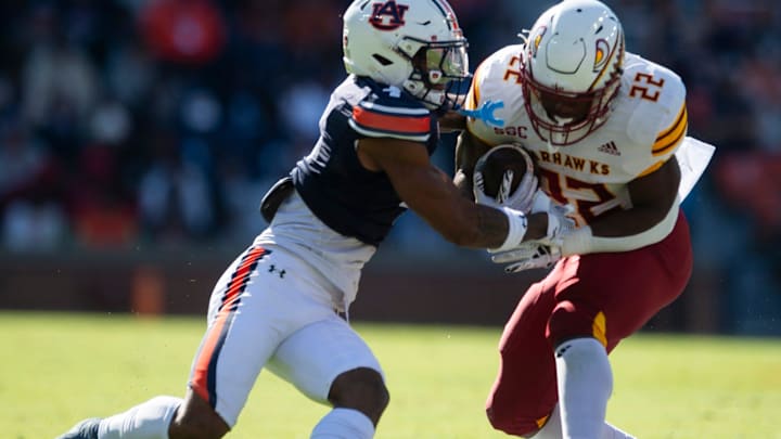 Louisiana-Monroe Warhawks running back Ahmad Hardy (22) breaks a tackle attempt from Auburn Tigers defensive back Kayin Lee (4) as Auburn Tigers take on Louisiana-Monroe Warhawks at Jordan-Hare Stadium in Auburn, Ala., on Saturday, Nov. 16, 2024. Auburn Tigers lead Louisiana-Monroe Warhawks 24-0 at halftime.