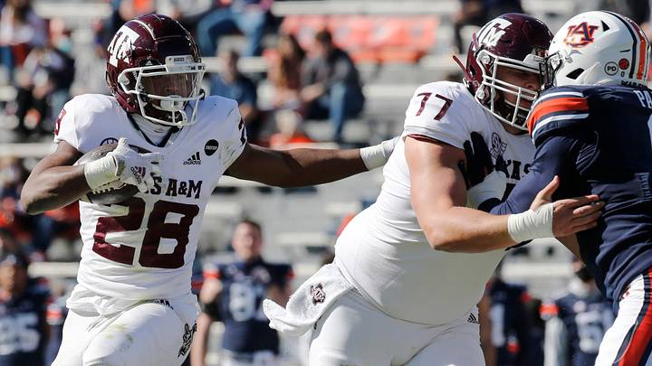 Dec 5, 2020; Auburn, Alabama, USA;  Texas A&M Aggies running back Isaiah Spiller (28) gets help from his offensive line during the first quarter against the Auburn Tigers at Jordan-Hare Stadium. Mandatory Credit: John Reed-USA TODAY Sports