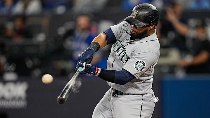 Seattle Mariners designated hitter Carlos Santana hits a double against the Toronto Blue Jays on Oct. 8, 2022, at the Rogers Centre.