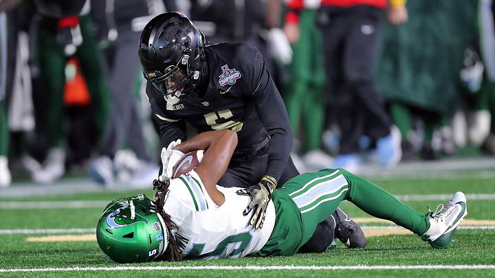 Dec 6, 2024; West Point, NY, USA; Army Black Knights cornerback Justin Weaver (5) tackles Tulane Green Wave wide receiver Yulkeith Brown (5) during the second half at Michie Stadium. Mandatory Credit: Danny Wild-Imagn Images Dec 6, 2024; West Point, NY, USA; Army Black Knights cornerback Justin Weaver (5) tackles Tulane Green Wave wide receiver Yulkeith Brown (5) during the second half at Michie Stadium. Mandatory Credit: Danny Wild-Imagn Images