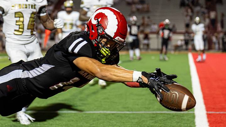 Manual's Brayland Miles dives for a touchdown during a game in September. The Crimsons have cracked the rankings' top 10 for the first time this season.  
