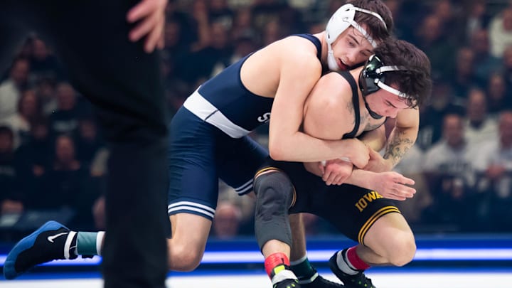 Penn State’s Luke Lilledahl, top, wrestles Iowa's Joey Cruz in the 125-pound bout of their Big Ten match in State College.
