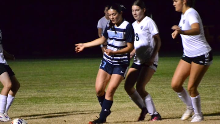 Reese McDougal of Seven Rivers Christian, 7, battles for the ball against Weeki Wachee in match on Dec. 20, 2024.