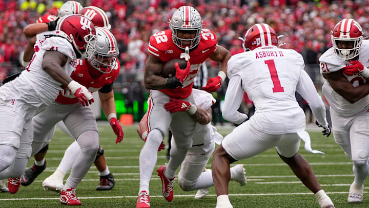 Ohio State Buckeyes running back TreVeyon Henderson (32) runs toward Indiana Hoosiers defensive back Shawn Asbury II (1) during the second half of the NCAA football game at Ohio Stadium in Columbus on Saturday, Nov. 23, 2024. Ohio State won 38-15.