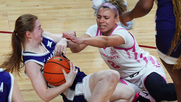 Iowa State Cyclones' guard Arianna Jackson (2) and Kansas State Wildcats guard Tess Heal (34) battle for a loose ball during the second quarter in the Big-12 conference women’s basketball on Feb. 15, 2026, at Hilton Coliseum, in Ames, Iowa.