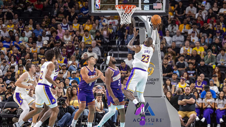 Oct 6, 2024; Palm Desert, California, USA: Los Angeles Lakers forward LeBron James (23) shoots a layup over Phoenix Suns guard Devin Booker (1) during the first half at Acrisure Arena. Mandatory Credit: David Frerker-Imagn Images Oct 6, 2024; Palm Desert, California, USA: Los Angeles Lakers forward LeBron James (23) shoots a layup over Phoenix Suns guard Devin Booker (1) during the first half at Acrisure Arena. Mandatory Credit: David Frerker-Imagn Images