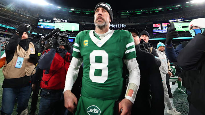 Jan 5, 2025; East Rutherford, New Jersey, USA; New York Jets quarterback Aaron Rodgers (8) walks on the field after the Jets win over the Miami Dolphins at MetLife Stadium. Mandatory Credit: Ed Mulholland-Imagn Images
