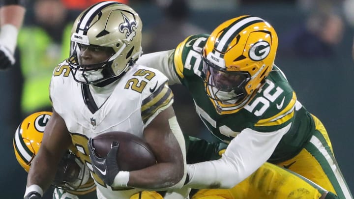 Green Bay Packers defensive end Rashan Gary (52) helps tackle New Orleans Saints running back Kendre Miller. Green Bay Packers defensive end Rashan Gary (52) helps tackle New Orleans Saints running back Kendre Miller.