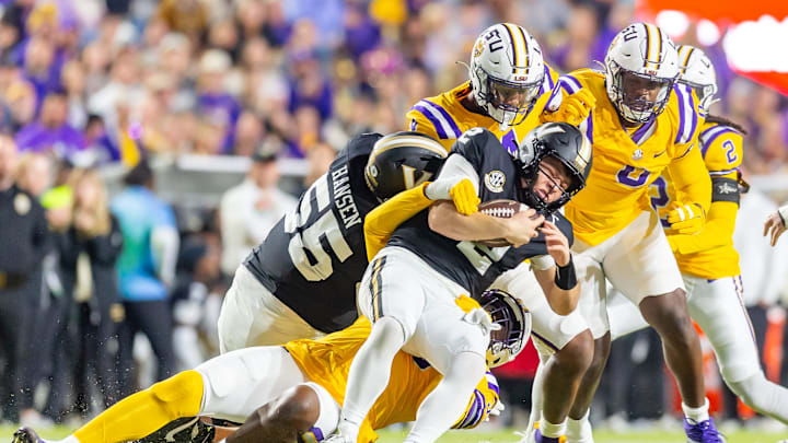Diego Pavia 2 is sacked by Defensive end Sai'vion Jones 35 as the Tigers LSU Tigers take on the Vanderbilt Commodores. Nov 23, 2024; Baton Rouge, Louisiana, USA; at Tiger Stadium.