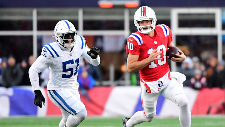Dec 1, 2024; Foxborough, Massachusetts, USA;  New England Patriots quarterback Drake Maye (10) runs the ball while Indianapolis Colts defensive end Kwity Paye (51) defends during the second half at Gillette Stadium.