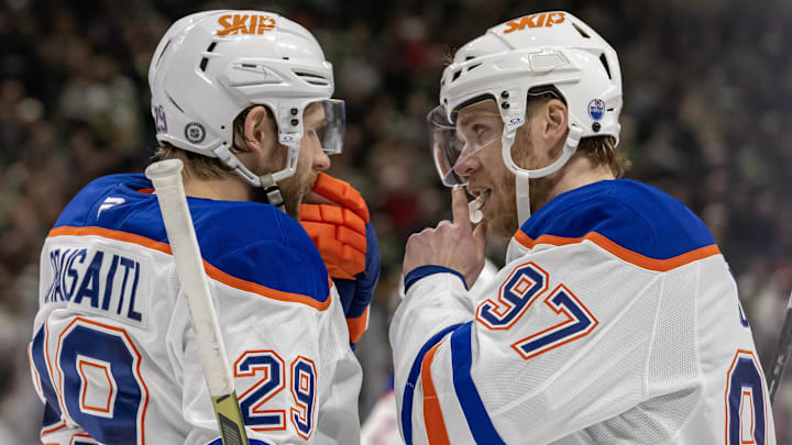 Jan 15, 2025; Saint Paul, Minnesota, USA;  Edmonton Oilers forward Leon Draisaitl (29) and forward Connor McDavid (97) talk before a face-off against the Minnesota Wild during the third period at Xcel Energy Center. Mandatory Credit: Nick Wosika-Imagn Images

