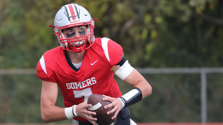 Somers quarterback Miguel Iglesias looks for an open man in their football game against Harrison at Somers High School, Oct. 13, 2024. Somers quarterback Miguel Iglesias looks for an open man in their football game against Harrison at Somers High School, Oct. 13, 2024.