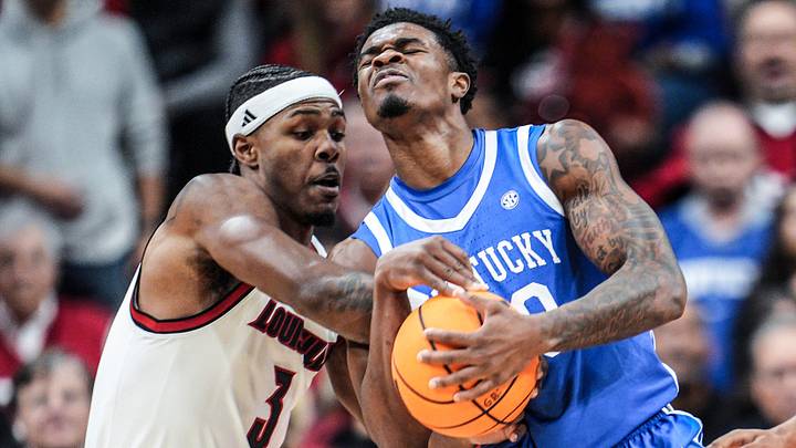 Louisville Cardinals guard Ryan Conwell (3) tussles with Kentucky Wildcats guard Otega Oweh (00)